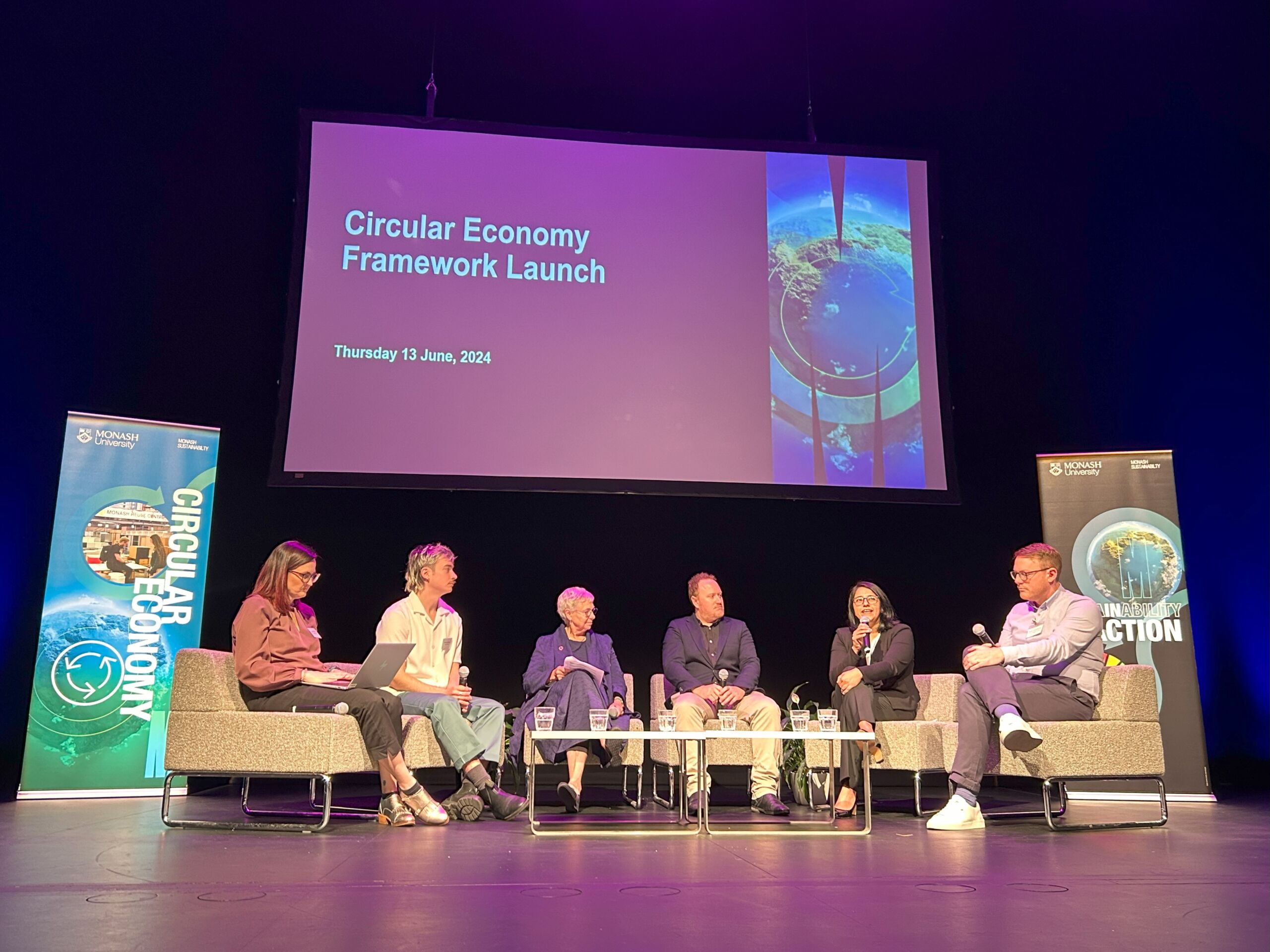 Image of professionals seated on a stage. Banner in the background reads 'Circular Economy Framework Launch'